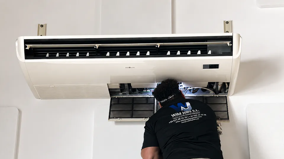 WildJobs technician servicing an air-conditioning unit